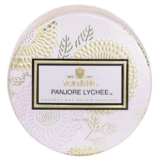 Round Voluspa Panjore Lychee candle packaging with decorative gold and pink design on a white background