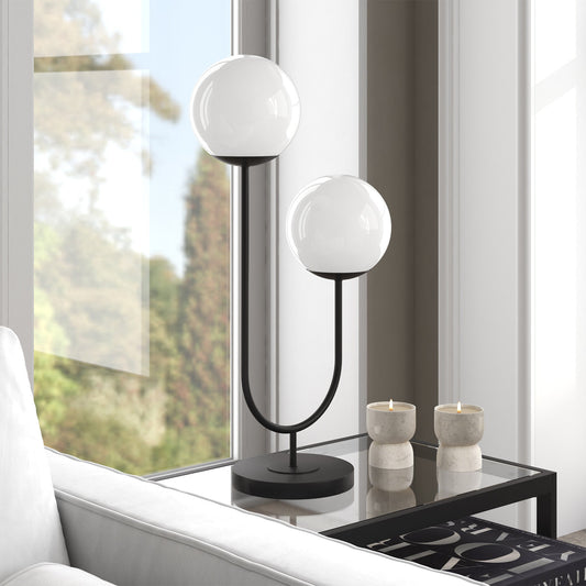 Modern table lamp with spherical design on a glass table near a window