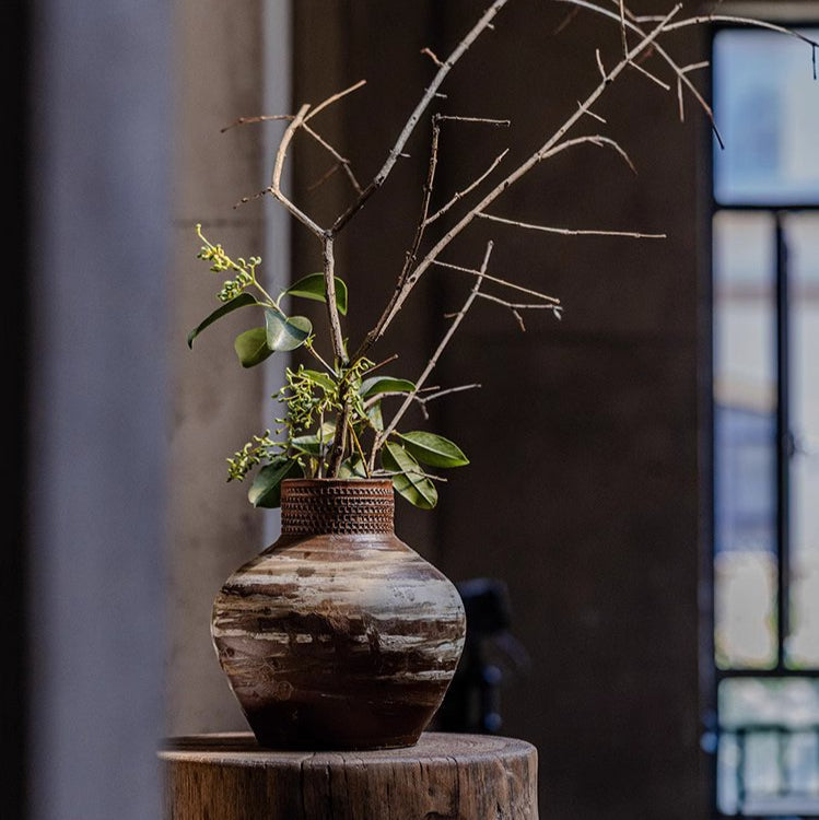 Large imperfect pottery as sculptural floor accent