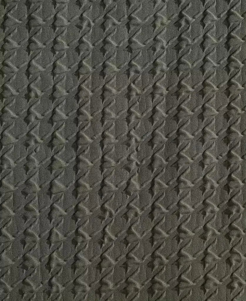 Close-up of dark green embossed houndstooth texture on Kenneth Cole duvet cover fabric.