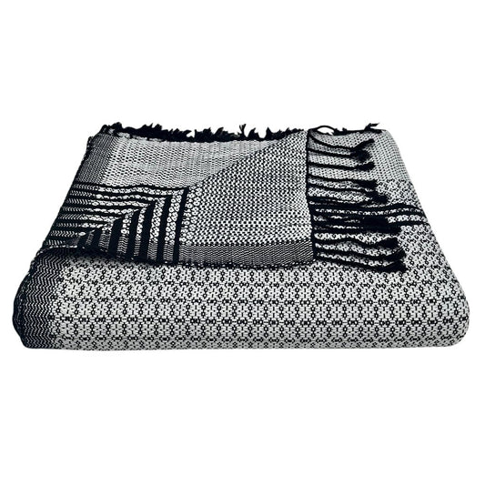 Silver and black Cambodian woven throw draped over modern sofa