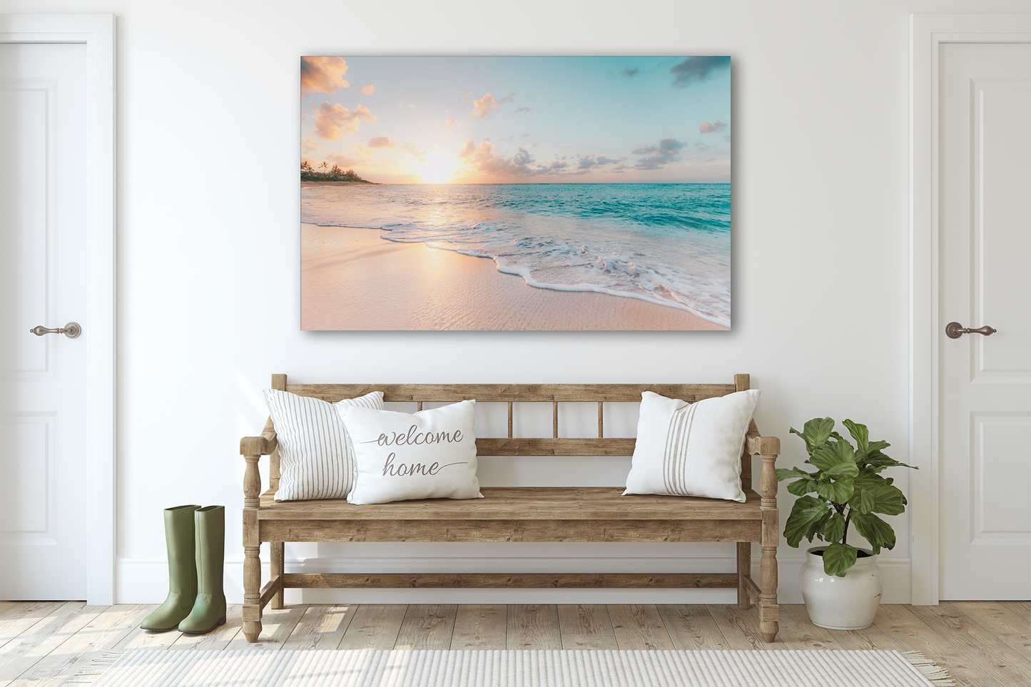A piece of glass art depicting a tranquil ocean scene with waves and a soft sunset or sunrise color palette, displayed above a wooden bench with cushions, in a bright interior setting.