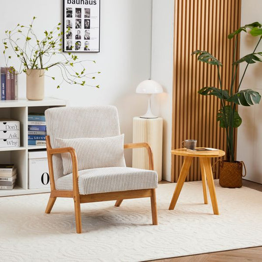 Modern living room with a gray armchair, side table, and decorative elements.