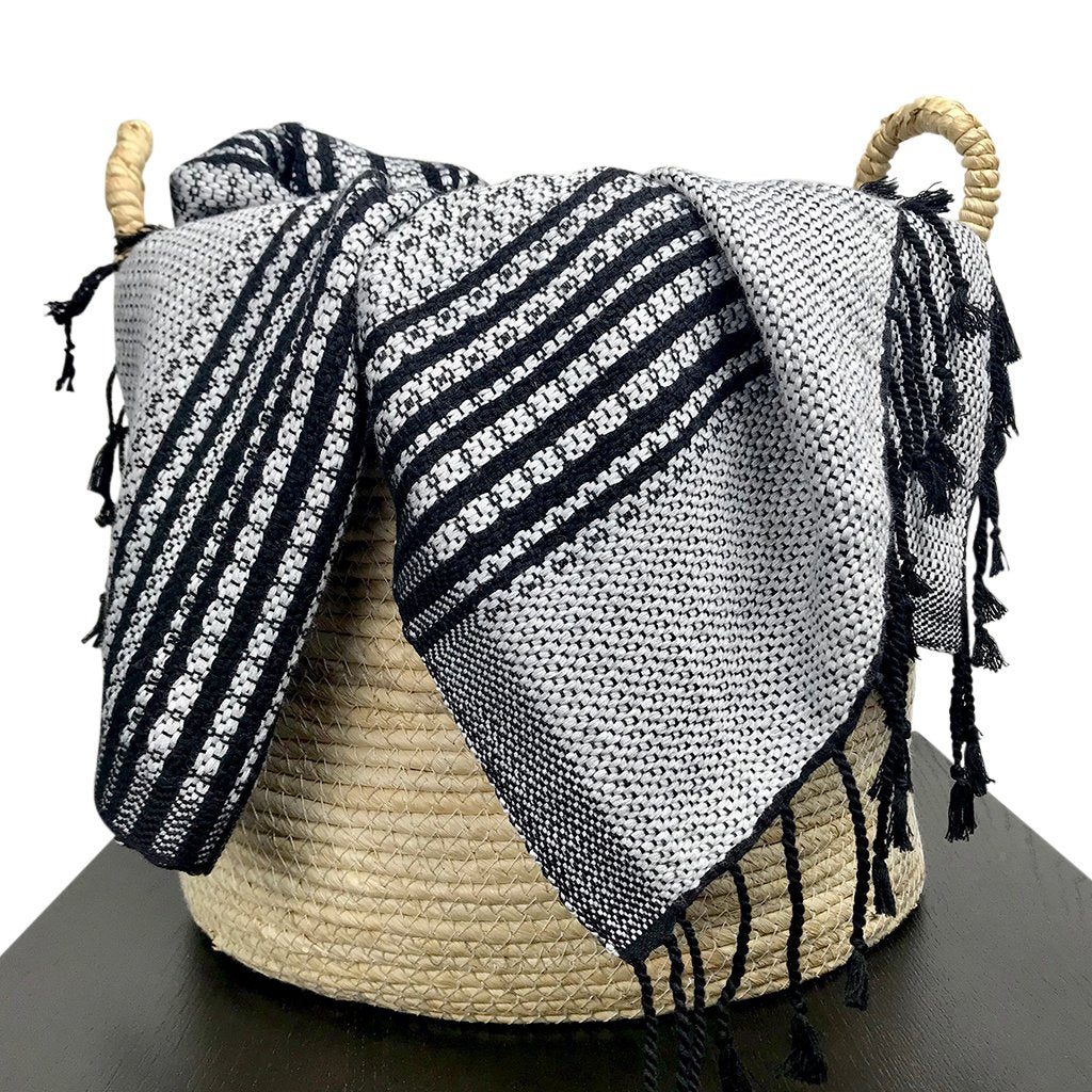 Ethically made bed runner with chevron detailing and hand-tied knots