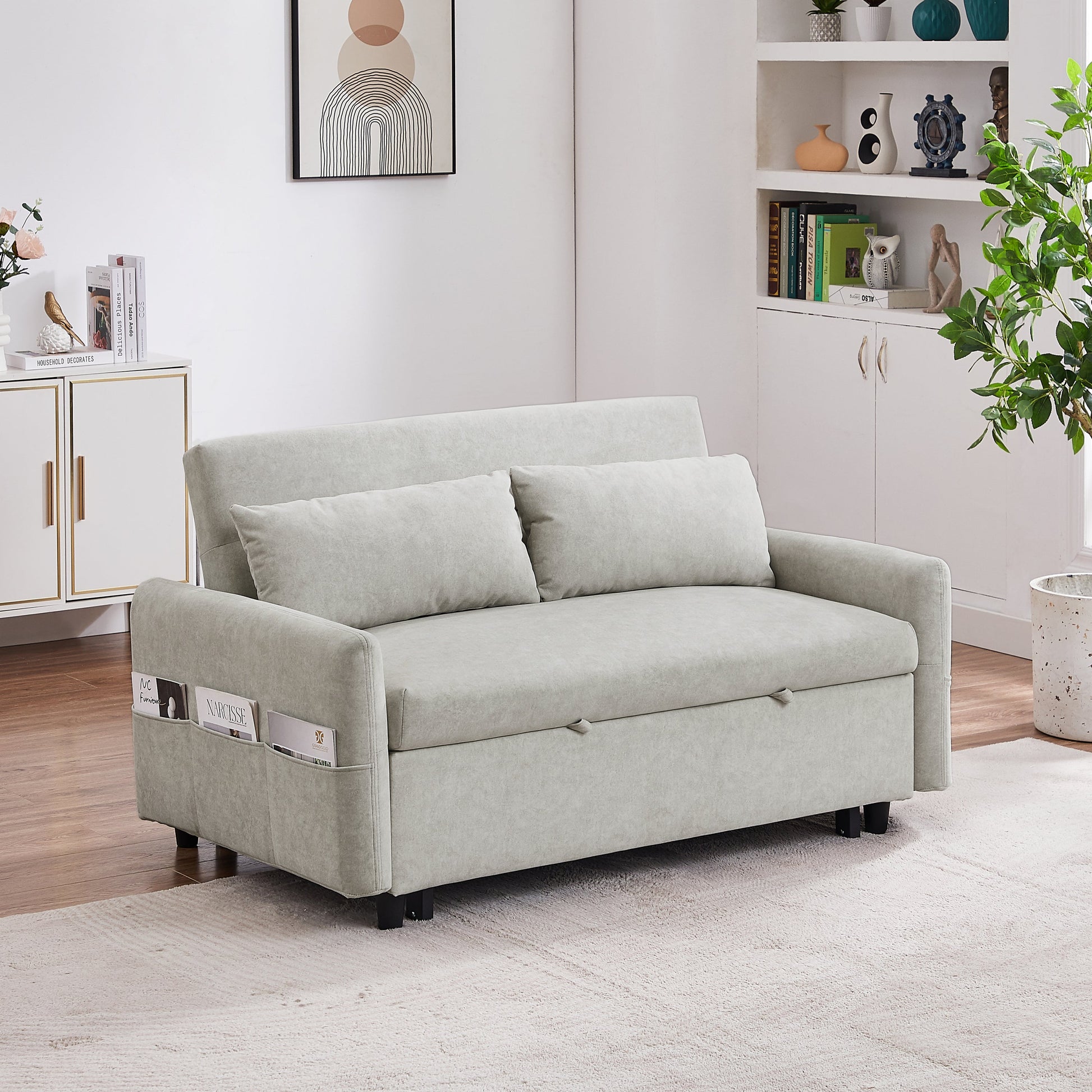 Light gray sofa bed in a living room setting with decor elements.