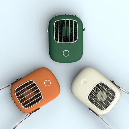 Three portable fans in green, orange, and beige on a light gray background