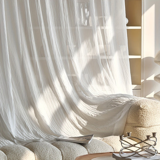 Sheer white curtain with rod pocket, allowing light to filter through, displayed in an interior setting with a bookshelf and decorative objects.