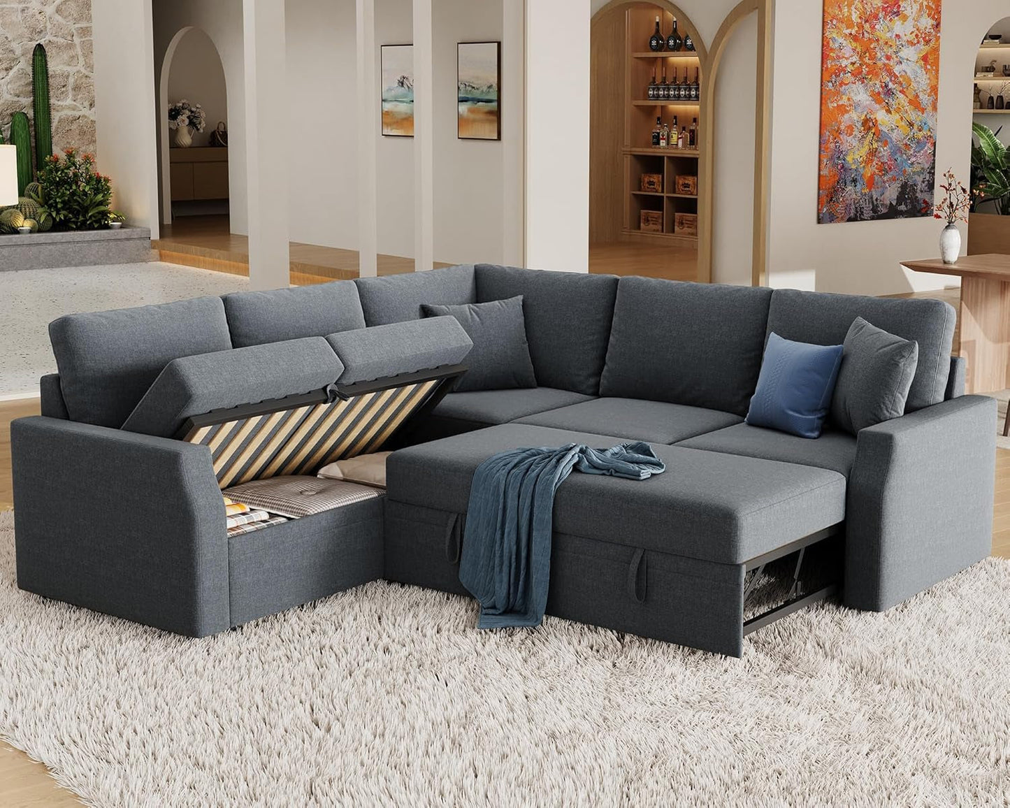 Gray sectional sofa in a living room setting with decorative pillows and a rug.