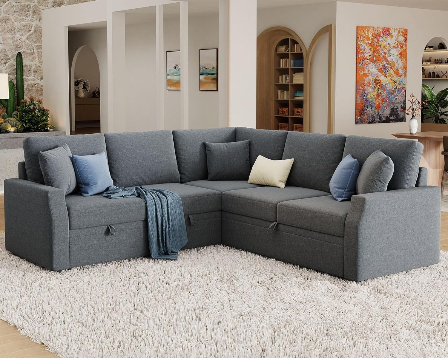 Gray sectional sofa in a living room with decorative pillows and a rug.