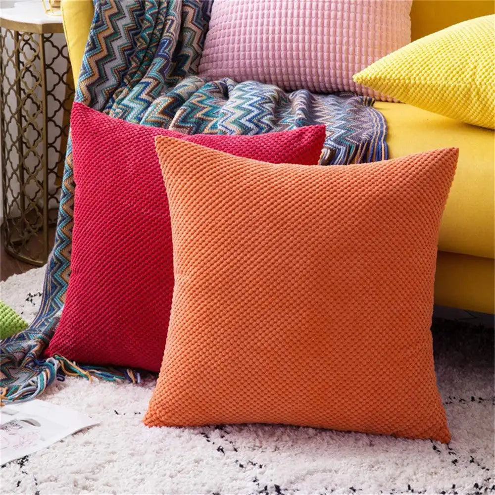 Colorful pillows on a textured surface with a blurred background