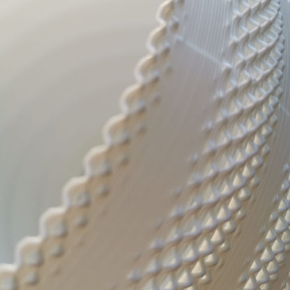 Close-up of a textured white fabric with a blurred background