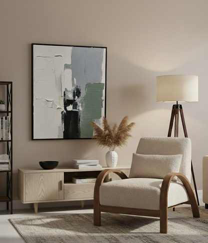 Modern living room with a beige armchair, wooden sideboard, and abstract art on the wall. Veteran owned.