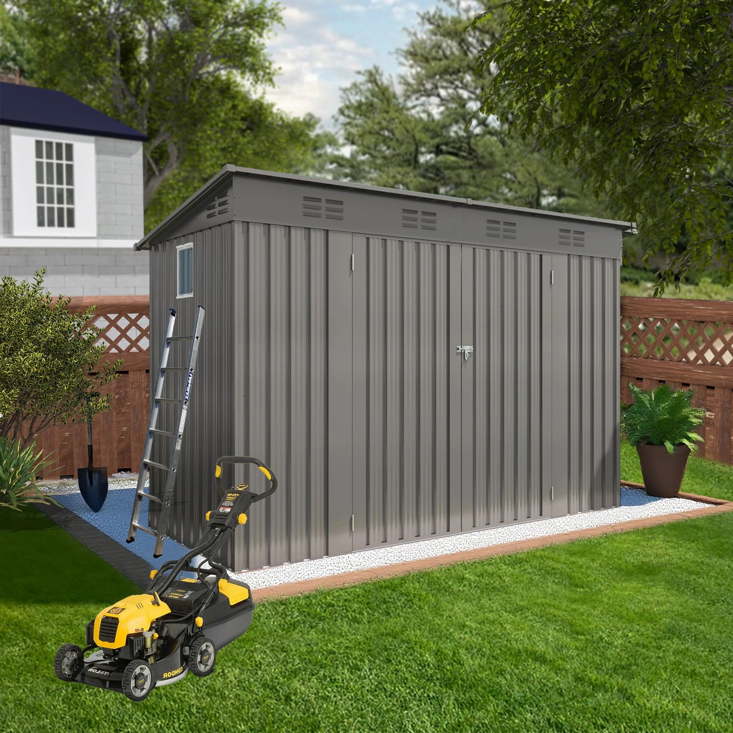 Gray metal storage shed with a lawn mower in front on a grassy area.