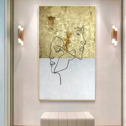 Abstract line art of a face on a textured gold and white background in a modern interior setting.