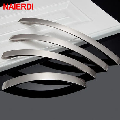 Four curved brushed metal cabinet handles in a silver finish, displayed on a white paneled surface with a dark reflective surface below. The brand name 'NAIERDI' is visible in red text in the top-left corner.
