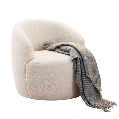 A modern round barrel chair upholstered in a textured cream bouclé fabric, styled with a gray woven throw blanket draped over the side, set against a plain white background.