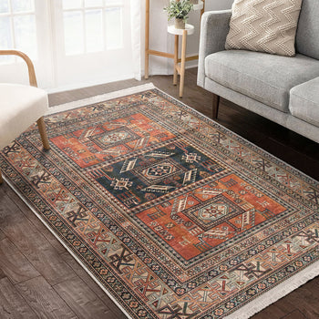 A vintage style area rug with geometric patterns in brown, black, and beige colors, placed on a wooden floor under a window with natural light coming in.