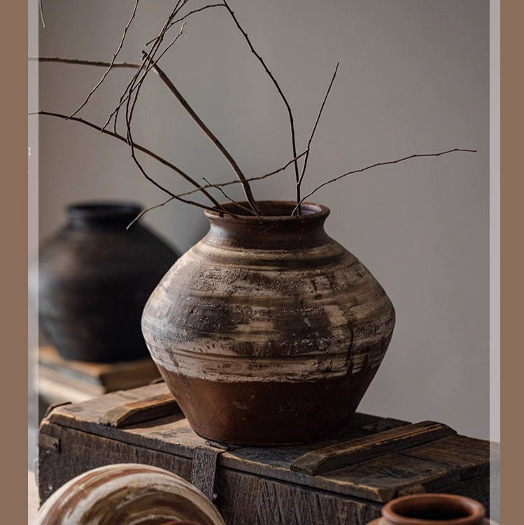 Large imperfect pottery as sculptural floor accent