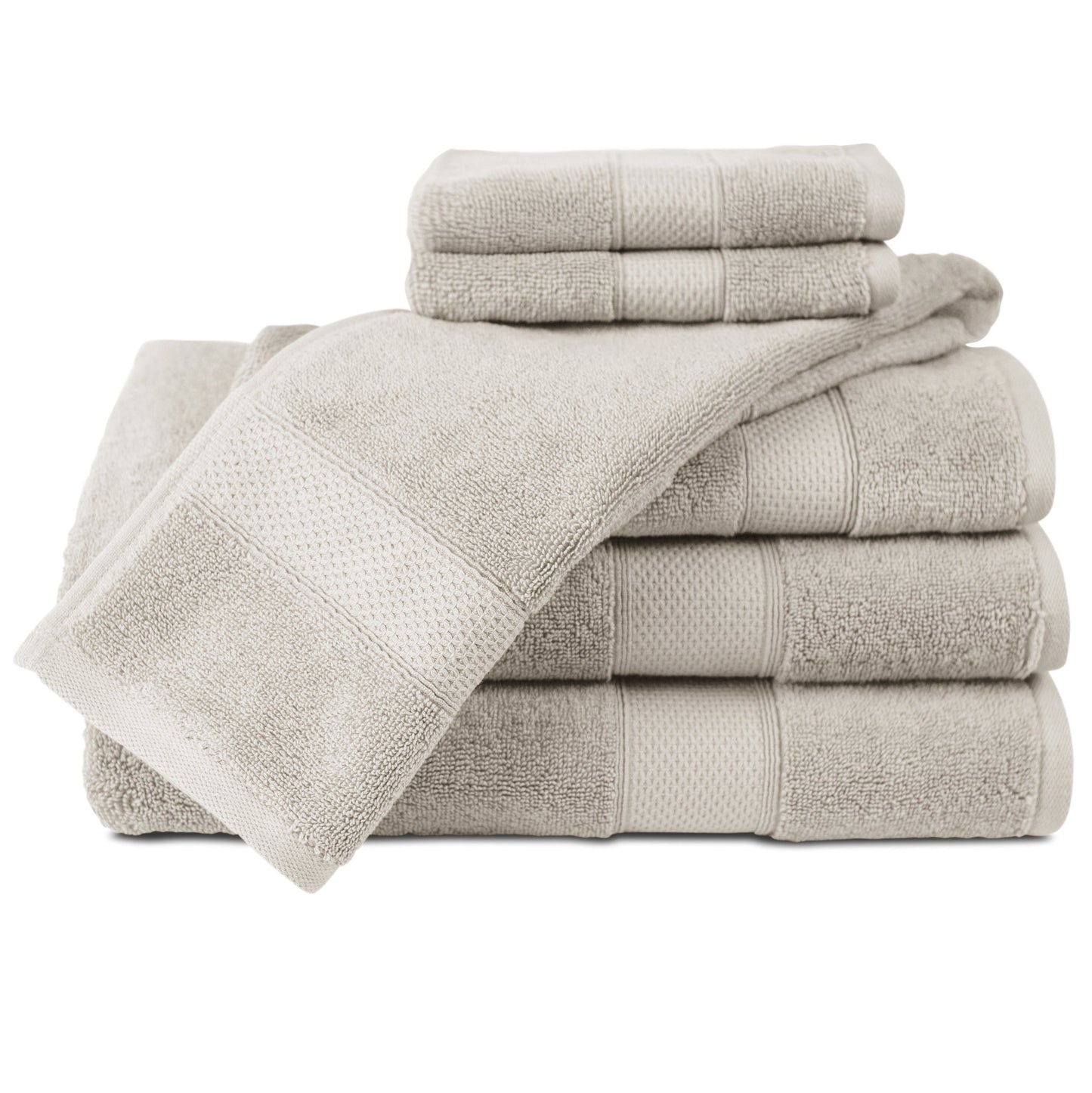 Set of beige towels stacked on a white background