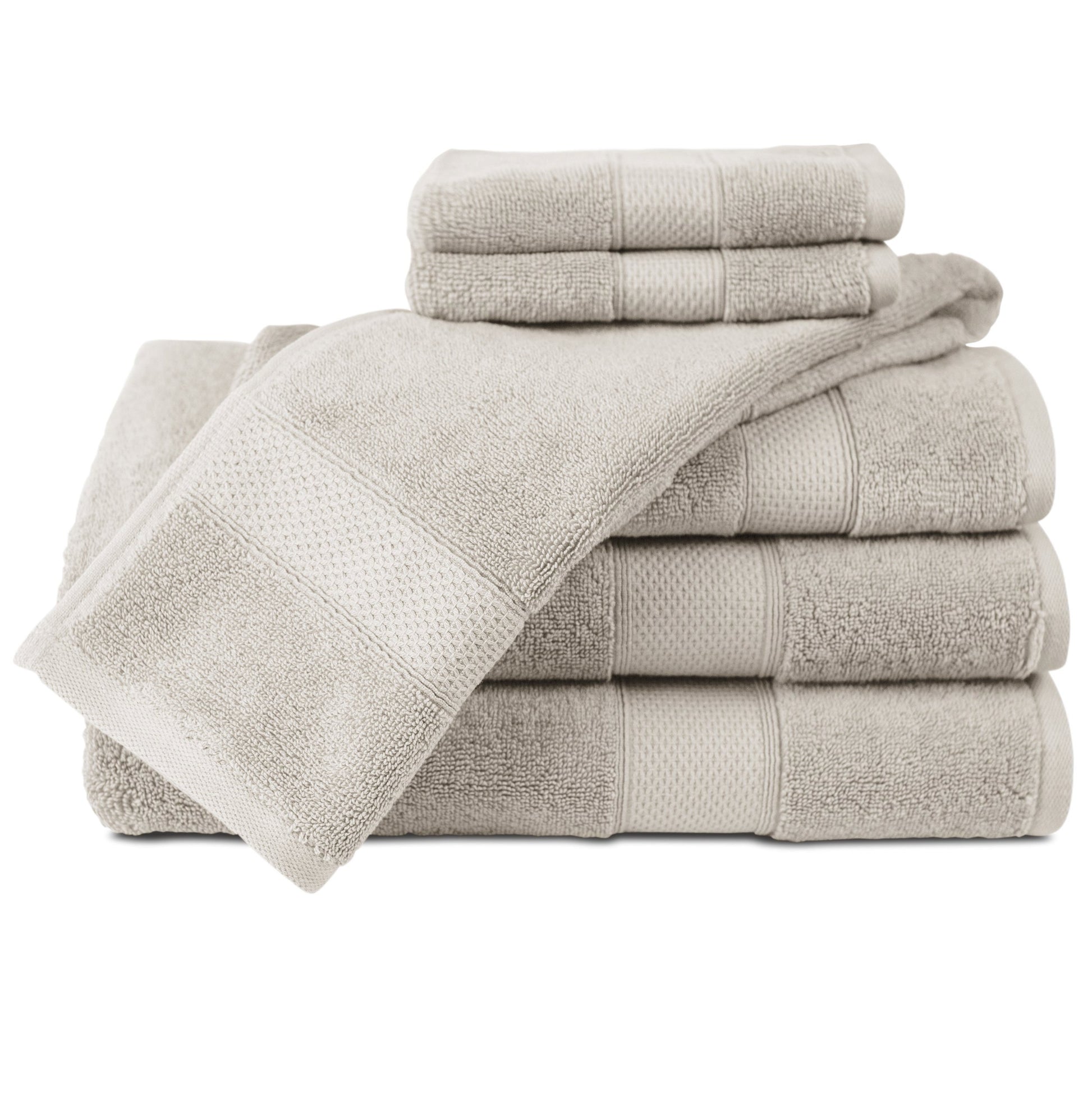 Set of beige towels stacked on a white background