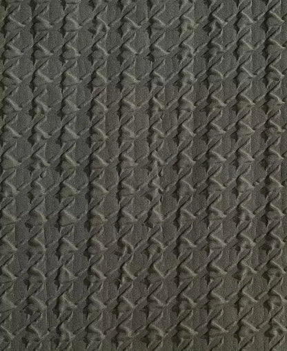 Close-up of dark green embossed houndstooth texture on Kenneth Cole duvet cover fabric.