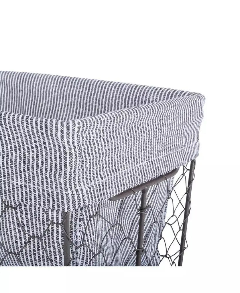Close-up of removable gray striped fabric liner fitted over an antiqued chicken-wire-style metal basket.
