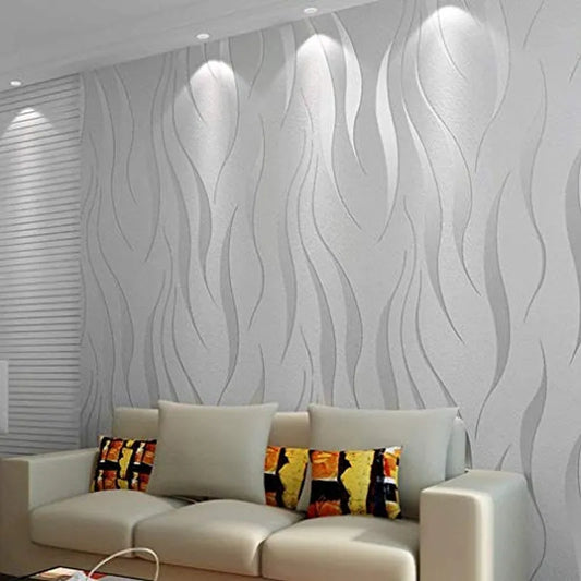 A wavy 3D embossed wallpaper with silver and purple hues in a living room setting, featuring a textured metallic wall covering.
