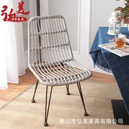 Woven chair in a room with a table and decor items, featuring the brand 'Hongmei'.