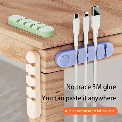 Cable management system with 3M glue on a wooden surface