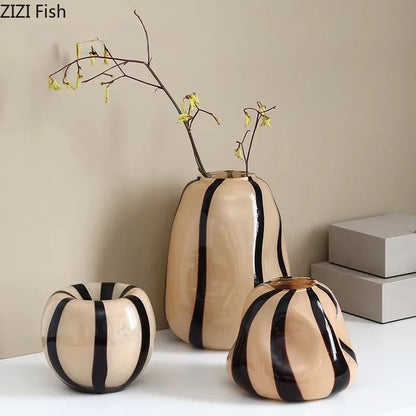 Set of three ceramic vases with black stripes on a neutral background, featuring the brand 'ZIZI Fish'.