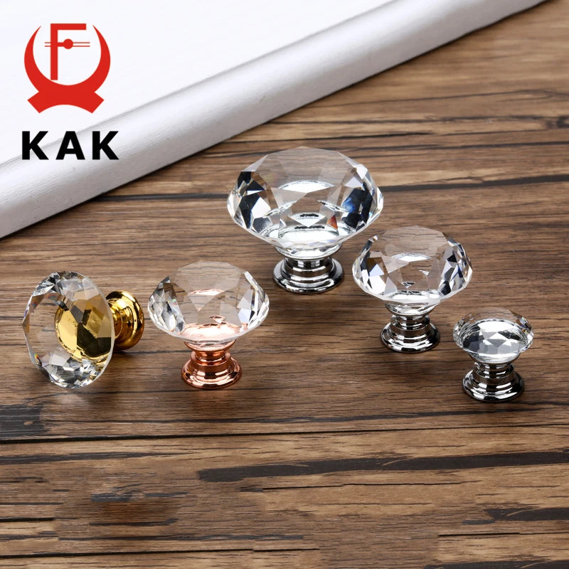 Set of crystal cabinet knobs in various colors on a wooden surface with KAK branding.
