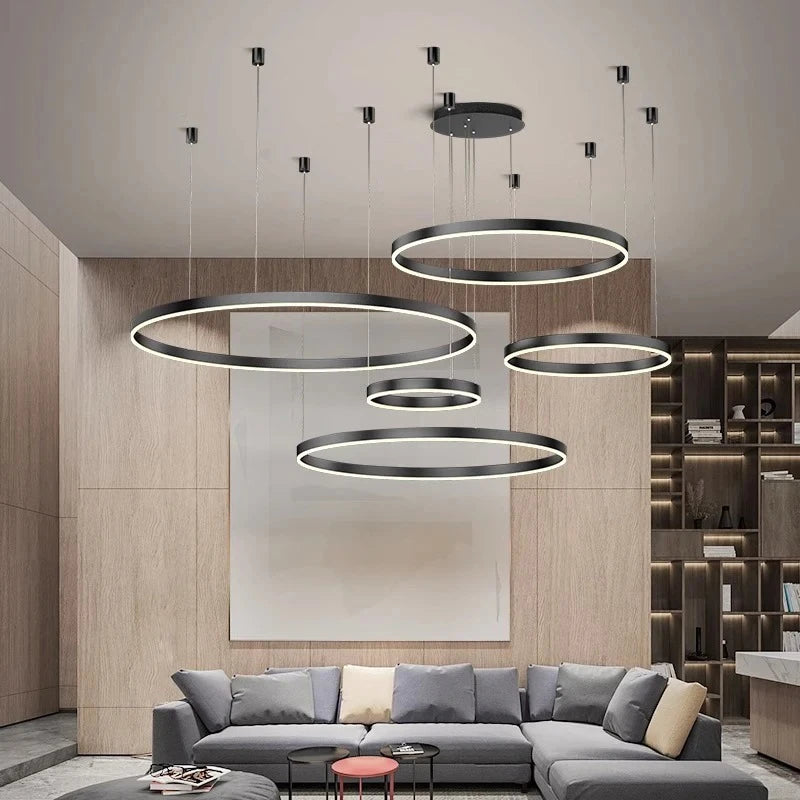 Modern living room with circular pendant lights and a gray sectional sofa.