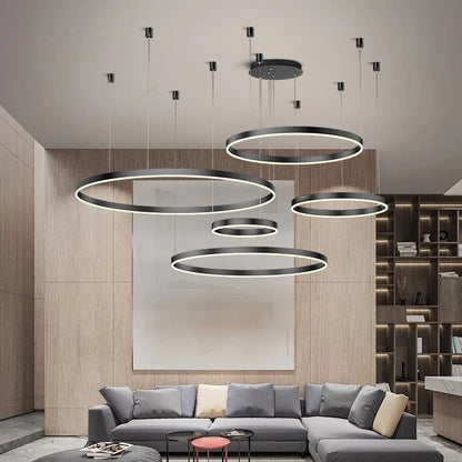 Modern living room with circular pendant lights and a gray sectional sofa.