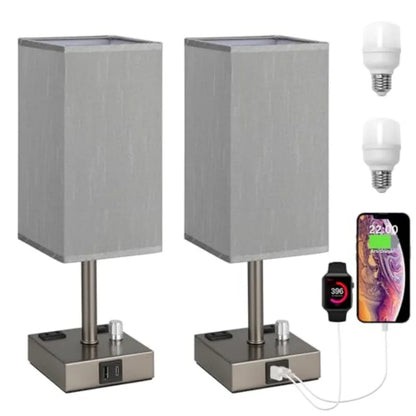 Two gray table lamps with charging ports and accessories on a white background