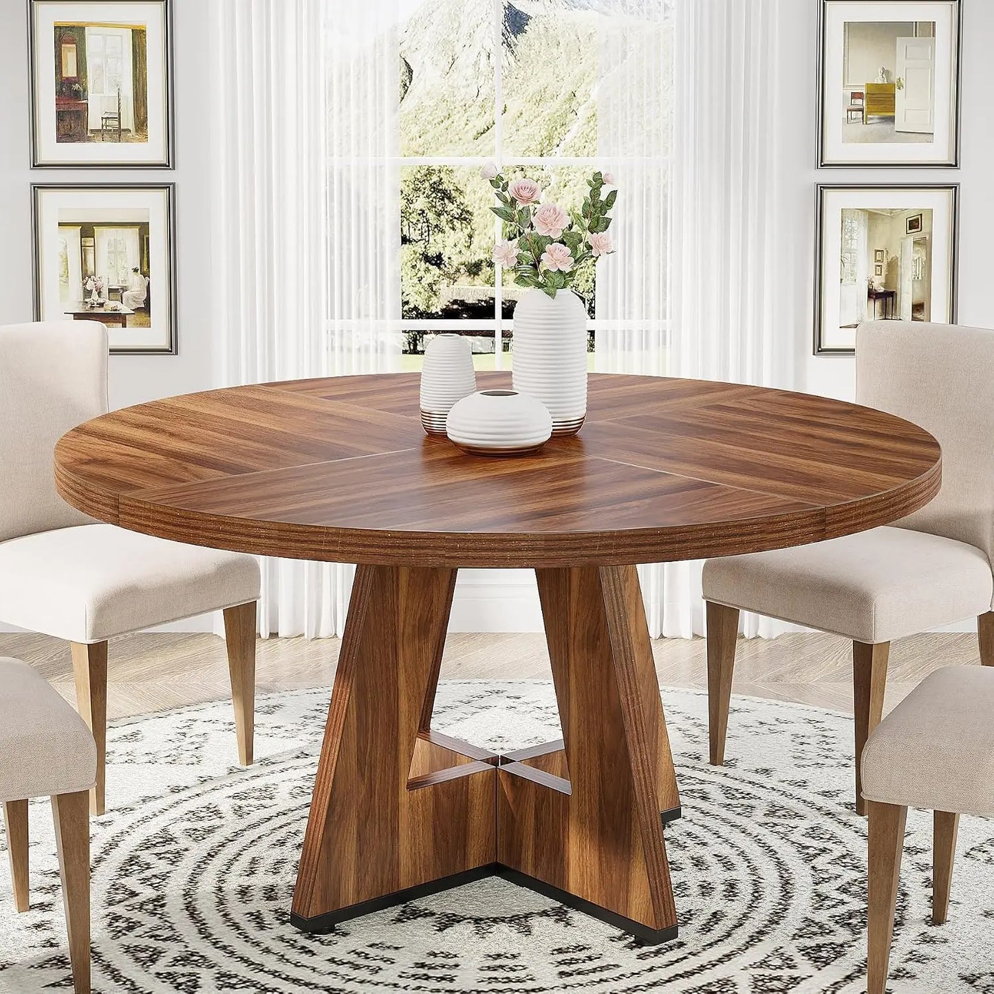 Round wooden dining table with chairs in a stylish room.