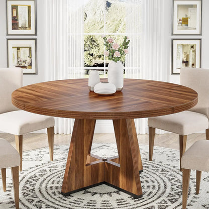Round wooden dining table with chairs in a stylish room.