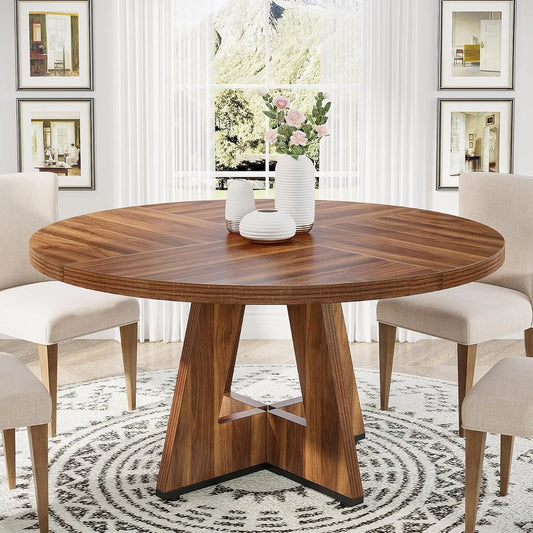 Round wooden dining table with chairs in a stylish room.