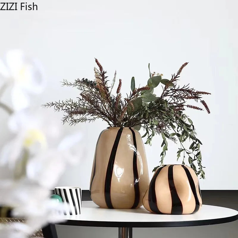 Two striped vases with dried plants on a white surface, branded 'ZIZI Fish'.