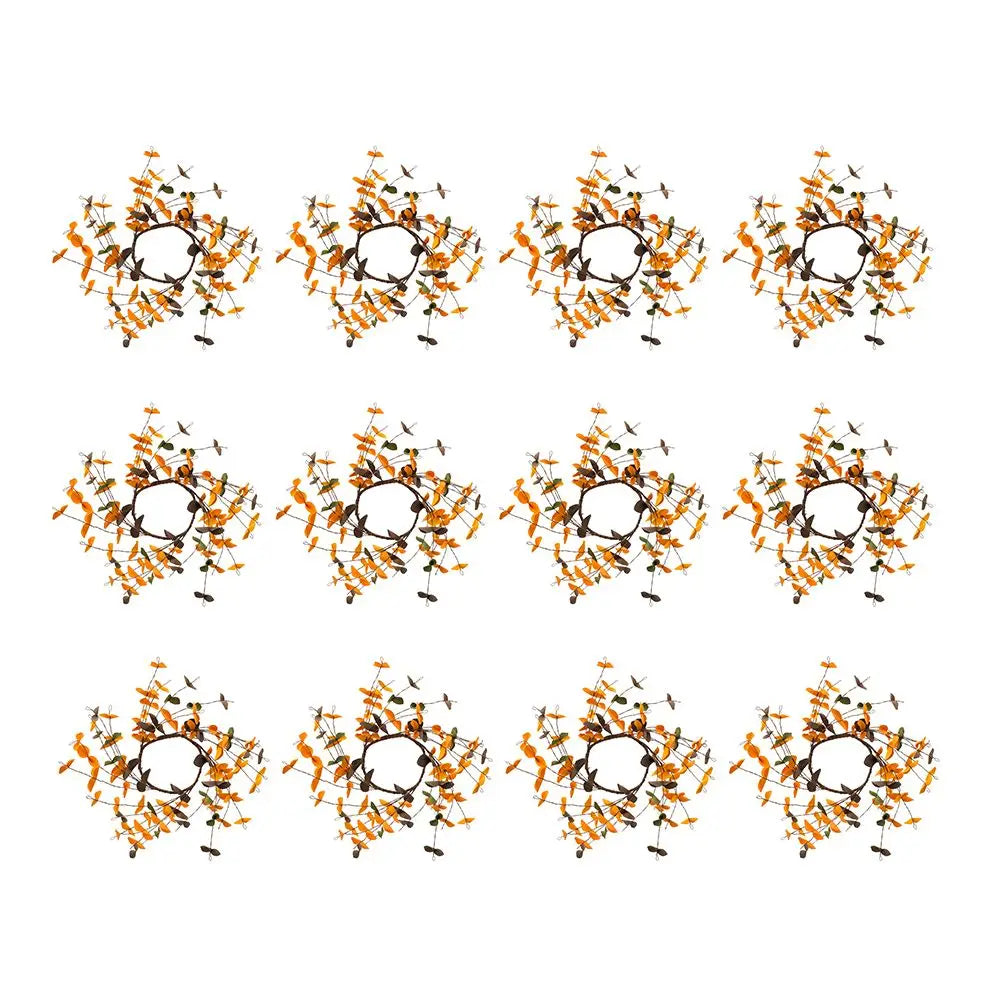 A repeating pattern of nine circular floral wreaths arranged in a 3x3 grid on a plain white background. Each wreath features orange and yellow flowers with dark green leaves and black stems.
