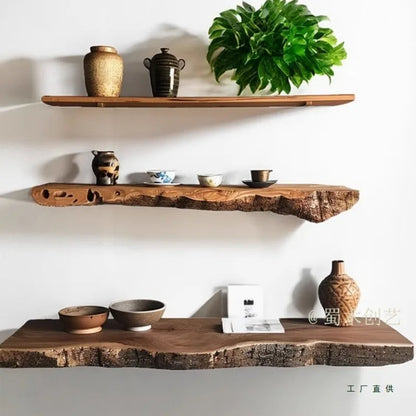 Three wooden shelves with decorative items against a white wall