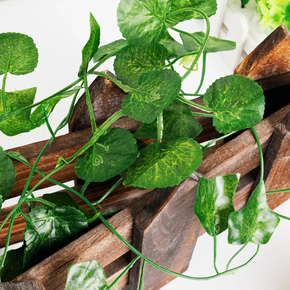 Artificial green leaves on a wooden surface