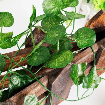 Artificial green leaves on a wooden surface