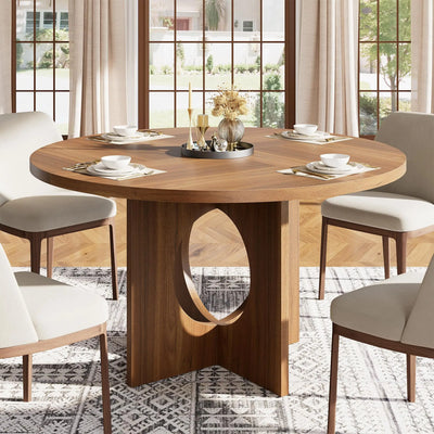 Dining room with a wooden table and chairs in a well-lit room.