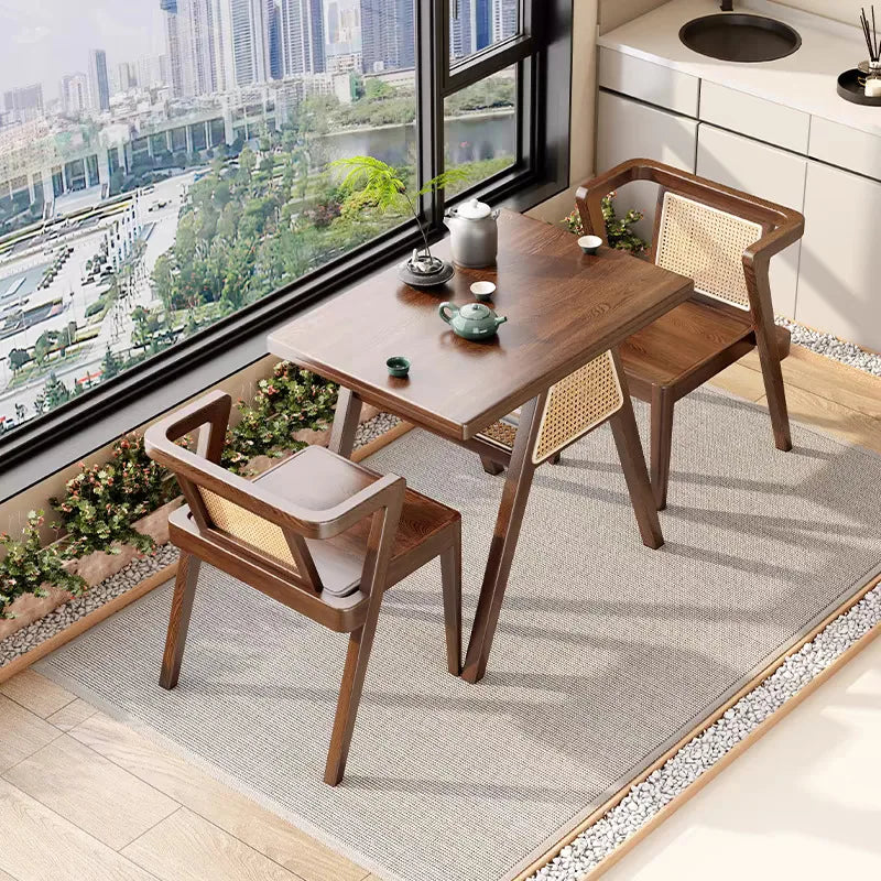 Wooden dining table with chairs in a room with large windows overlooking a cityscape.