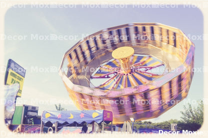 Golden spinning carnival ride photography print with colorful lights and motion blur from an amusement park attraction.