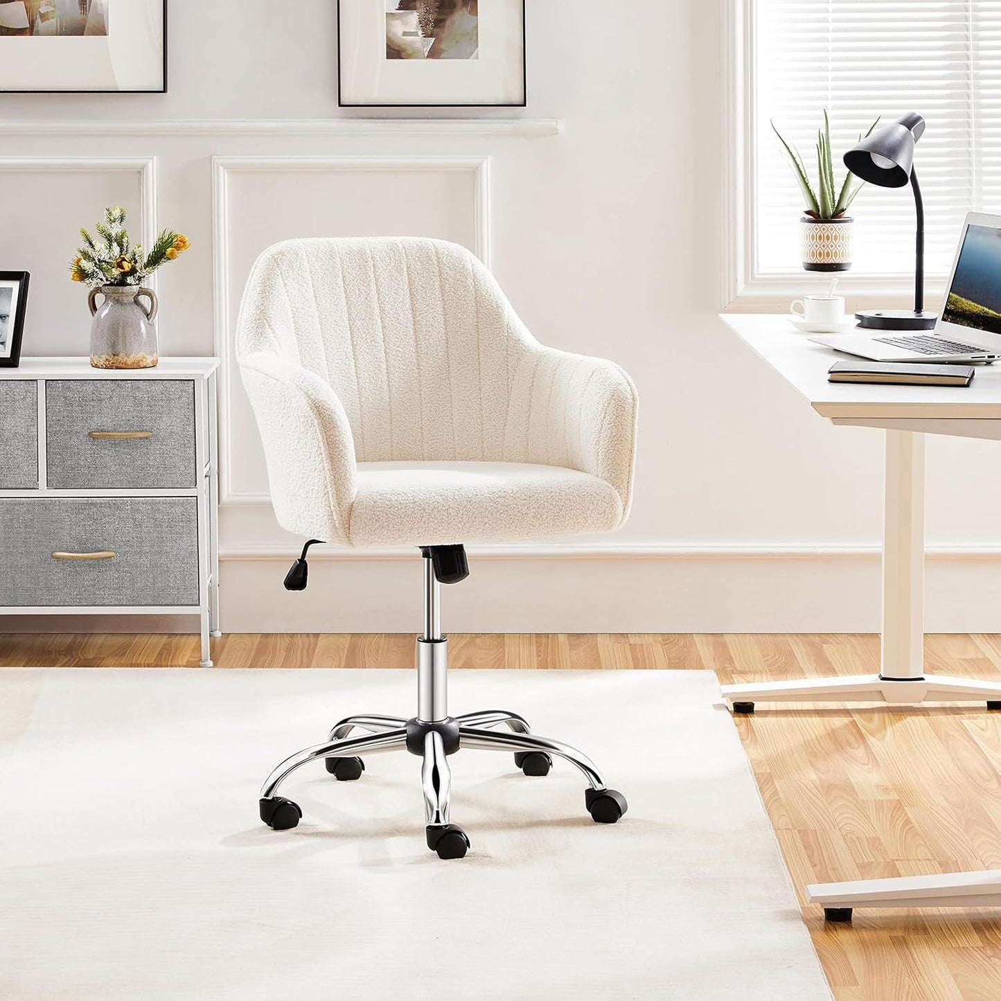 White office chair in a home office setting with a desk and decor.