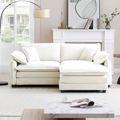White sofa in a living room with a fireplace and decor