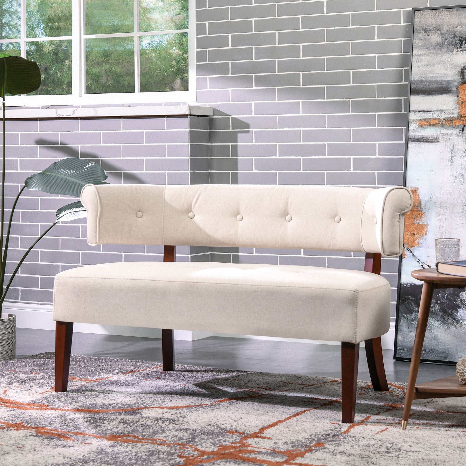 Beige tufted bench in a room with gray tiled wall and decorative rug