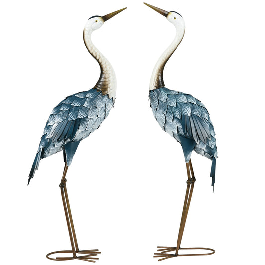 Two decorative heron statues on a white background