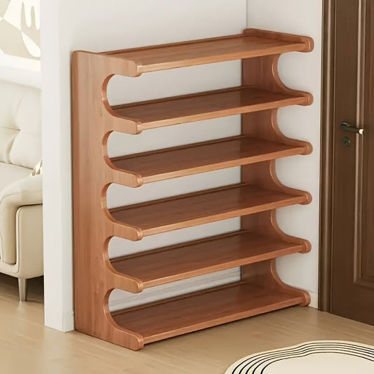Wooden shoe rack against a wall in a room with a couch and door.